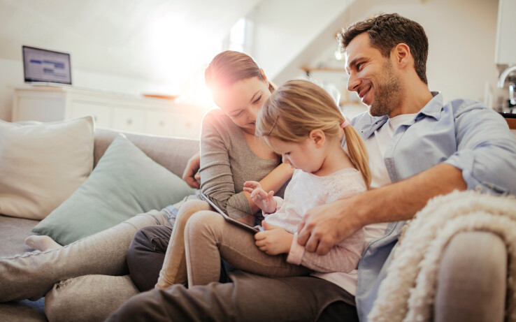 Énergie solaire thermique : toute la famille est assise ensemble sur le canapé et profite d'une énergie durable issue du soleil