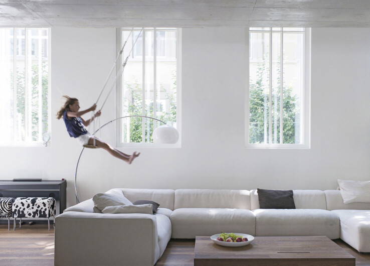 Reportage architectural à Berne : la hauteur sous plafond permet même d'installer une balançoire pour enfants dans le salon